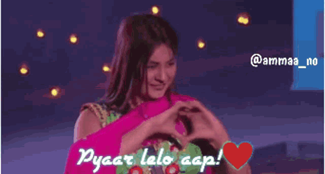 a woman making a heart shape with her hands with the words pyaar lalo cap written on the bottom