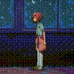 a girl with red hair is standing in front of a window in a room .