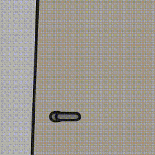 a cartoon character is peeking out from behind a door with a door handle .