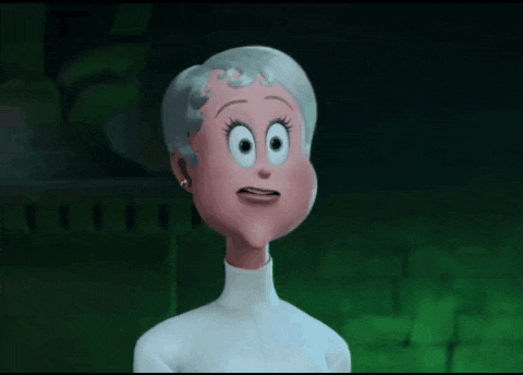 a cartoon woman with gray hair and big eyes is making a funny face .