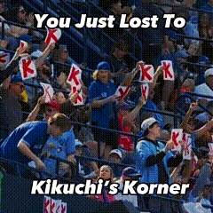 a crowd of people in a stadium holding signs that say kikuchi 's korner