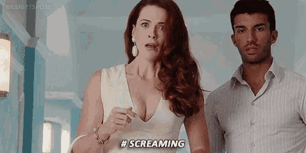 a woman in a white dress is screaming while standing next to a man in a white shirt .