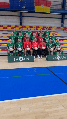 a group of soccer players are posing for a photo in front of a banner that says jaxan