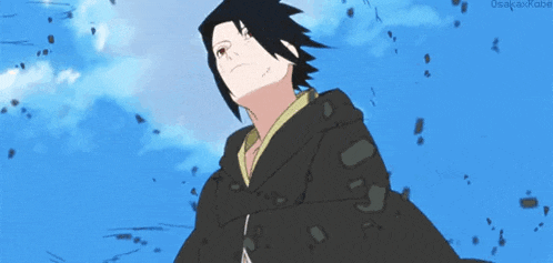 a man in a black jacket is standing in front of a blue sky with clouds .