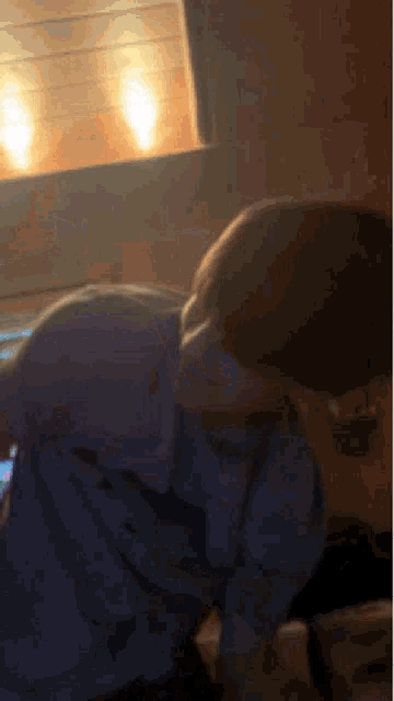 a blurry picture of a person looking at a cellphone