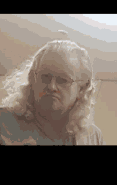 a close up of a woman wearing glasses and long blonde hair