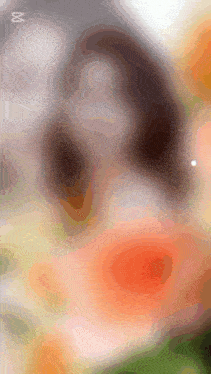 a blurred image of a person 's face with a x on the bottom