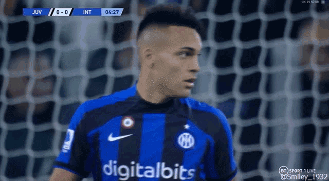 a soccer player wearing a digital bits jersey stands in front of a goal