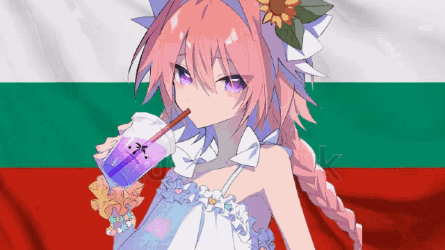 a girl drinking a drink with a straw in front of a flag