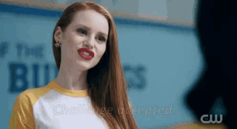 a woman with red lips is wearing a yellow and white shirt that says challenge accepted on it