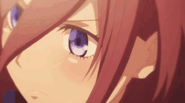 a close up of a girl 's face with red hair and purple eyes