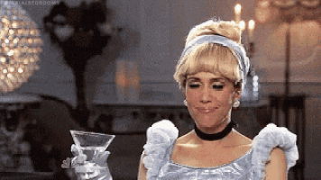 a woman dressed as cinderella is holding a martini glass in her hand .