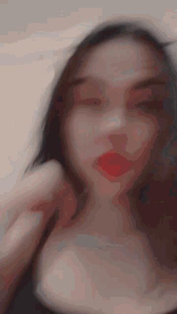 a blurry picture of a woman 's face with red lips