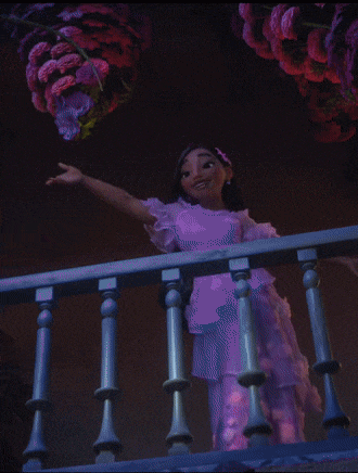 a woman in a purple dress stands on a balcony