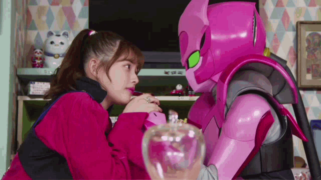 a girl and a robot are looking at each other in a room