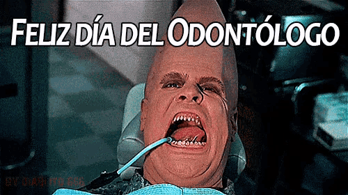 a man is in a dental chair with the words feliz dia del odontologo above him
