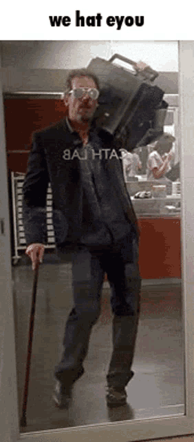 a man with a cane is carrying a suitcase over his head and says we hat eyou on the bottom