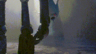 a person is standing on a pole in a foggy room holding a pipe .