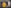 a blurry picture of a yellow object in the middle of a room .