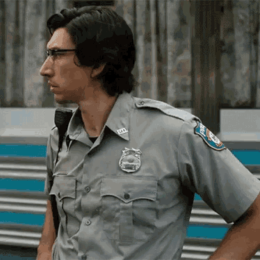 a man in a police uniform has a badge on his shoulder that says u.s. army