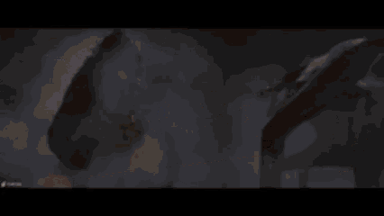 a monster with a blue light coming out of its mouth is being attacked by another monster