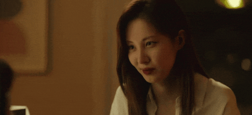 a close up of a young man looking at a woman 's face .