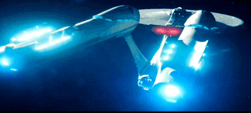 a space ship is flying through the air with blue lights