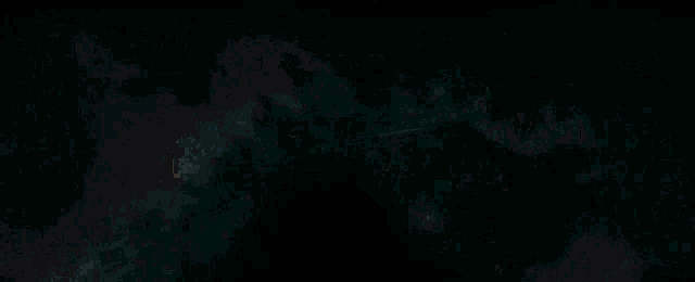 a close up of a monster with its mouth open in a dark room .