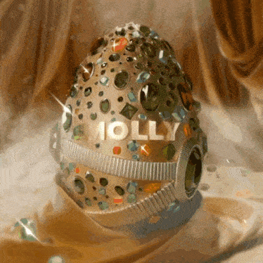 molly is written on a jeweled egg on a table
