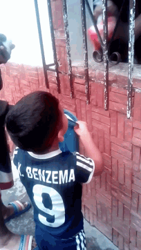 a boy wearing a shirt that says benzema on the back of it