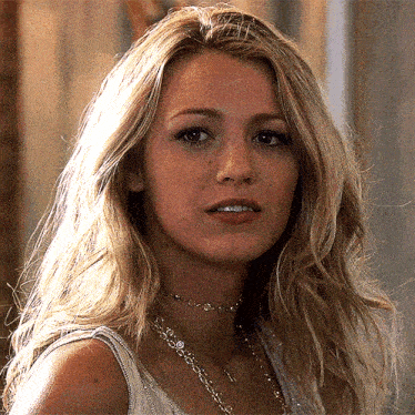 a close up of a woman 's face wearing a choker and a tank top