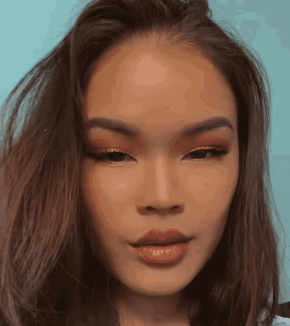 a close up of a woman 's face with red eye shadow