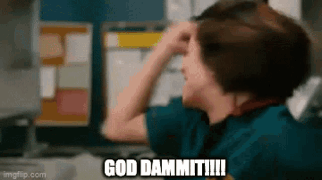 a man is sitting in front of a computer with his hand on his forehead and the words god dammit written on the screen