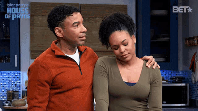 a man and a woman are standing in a kitchen with the words house of payne in the background