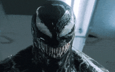 a close up of venom 's face with a huge smile
