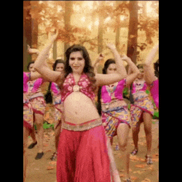 a woman is dancing in front of a group of women .