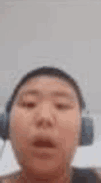 a man wearing headphones is making a funny face .