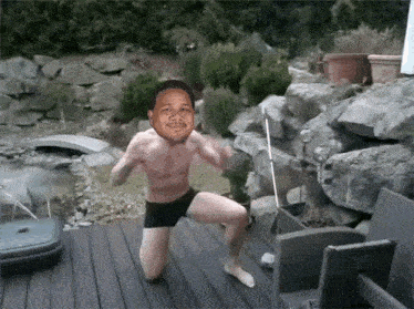 a man without a shirt is squatting on a deck