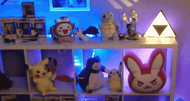 a shelf filled with stuffed animals including a pink bunny pillow
