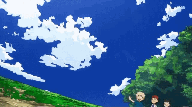 a group of people standing on top of a hill looking at the sky
