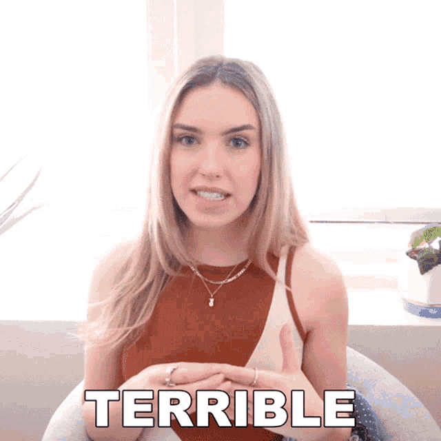 a woman is giving a thumbs up and the word terrible is behind her