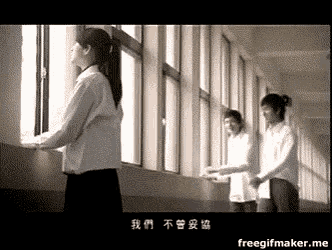 a group of people standing in a hallway looking out a window