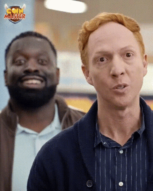 a man with red hair is standing next to another man with a coin master logo