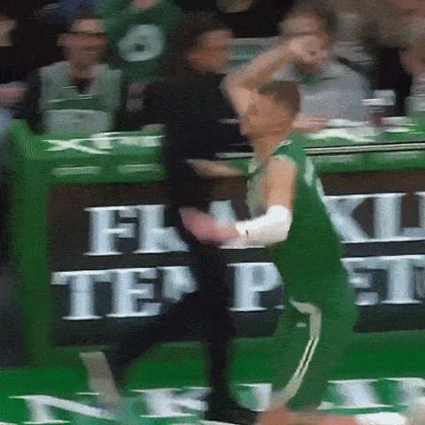 a basketball player in a green jersey with the number 8 on the back
