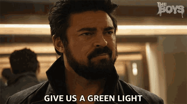 a man with a beard says give us a green light on a screen