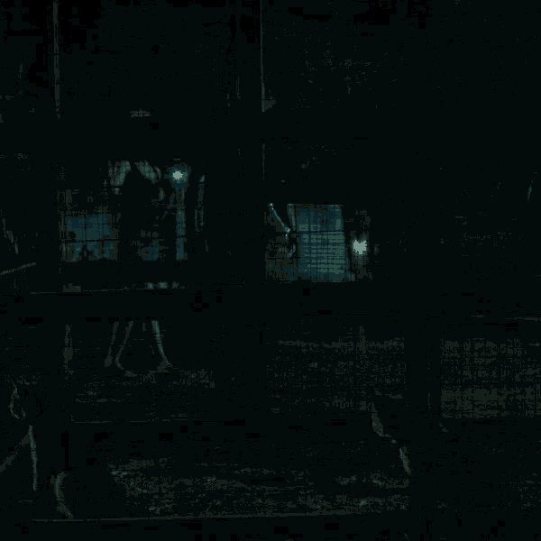 a woman is pointing a gun in the dark