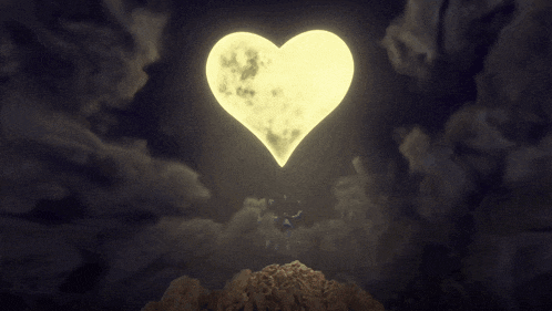 a full moon in the shape of a heart shines brightly in the night sky