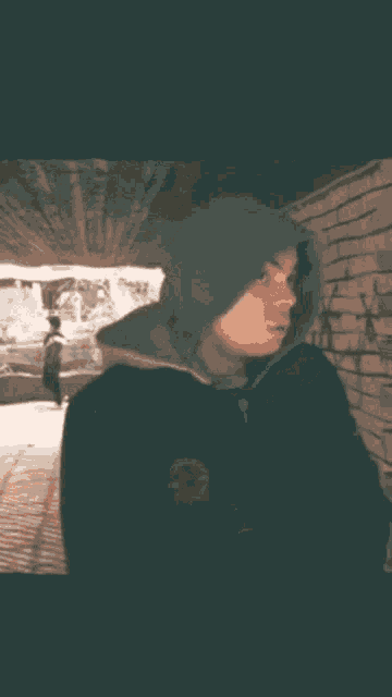 a man in a hooded jacket with the words pa dal written on the bottom