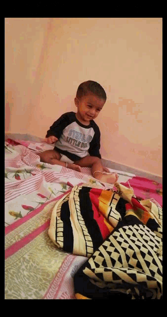 a little boy wearing a shirt that says stella little boy