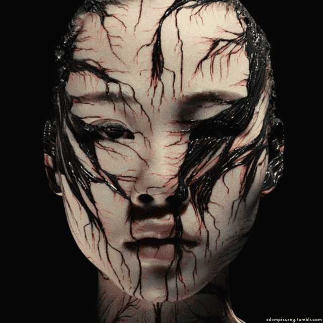 a close up of a woman 's face with a black background and a tumblr.com link at the bottom